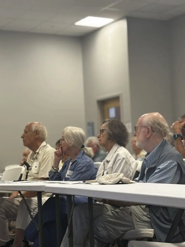 senior citizens sit at a white table at a free senior education program in southern Maine