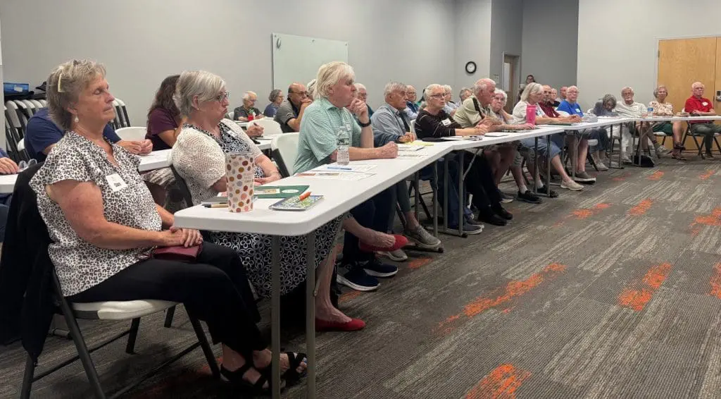 Adults sitting around a table at a Free senior education programs